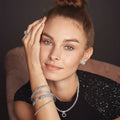 Model wearing a stack of Bangle bracelets