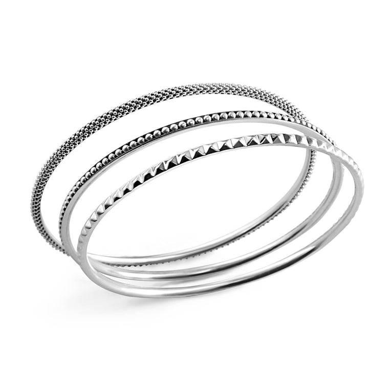 Signature Caviar Silver Bangle Set featuring three sterling silver bangles with distinct textures: classic Caviar beading and striking sugarloaf motif, showcasing elegant craftsmanship.
