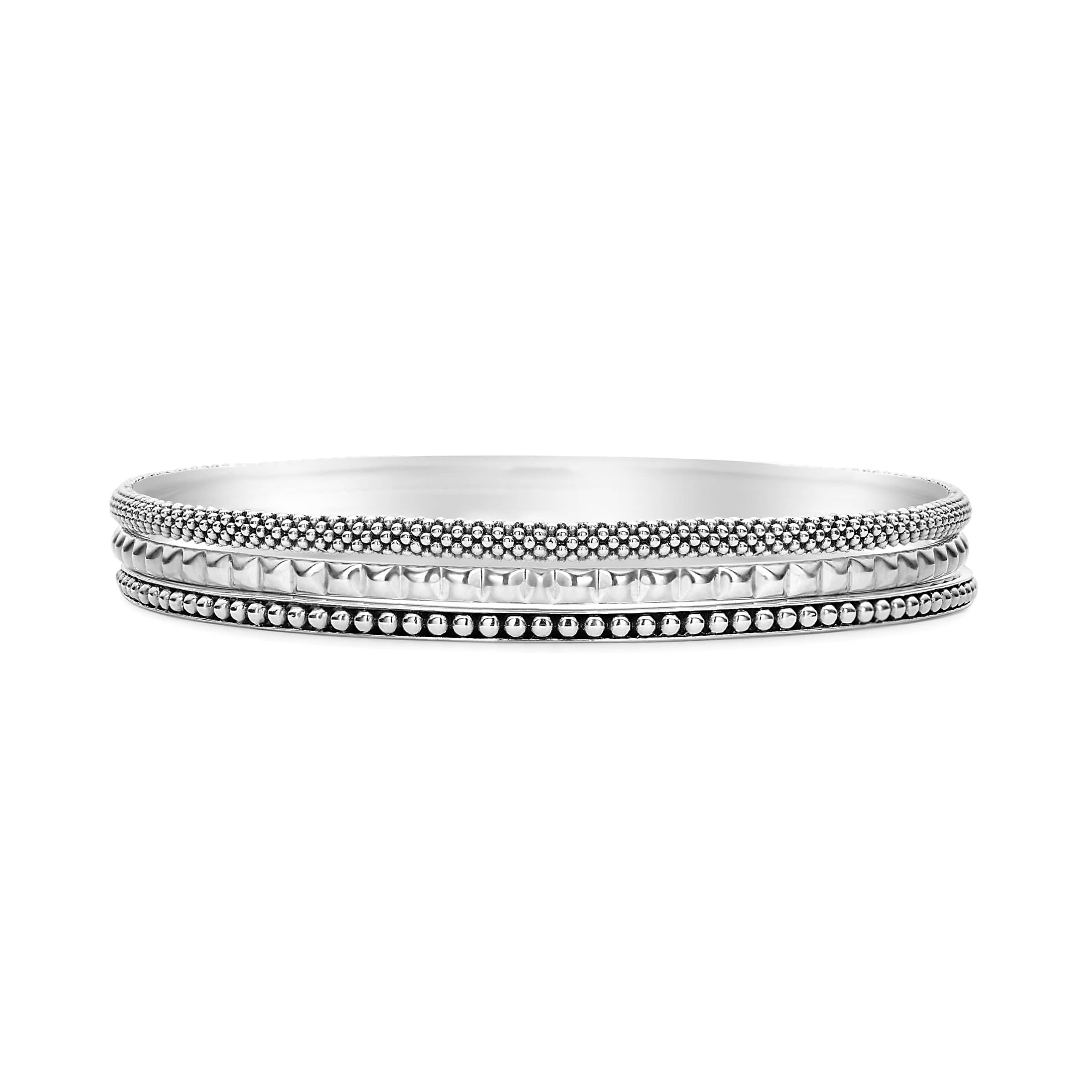 Signature Caviar Silver Bangle Set featuring three sterling silver bangles with varied decorative edges: beading, folded-metal, and sugarloaf motifs, showcasing timeless elegance and modern sophistication.