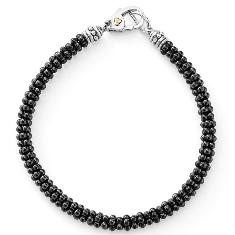 A black ceramic Caviar bracelet that is finished with a sterling silver lobster clasp detailing an 18K gold LAGOS crest.