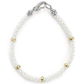 A white ceramic Caviar bracelet accented by five 18K gold stations.