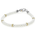 White Caviar Five Gold Station Ceramic Bracelet features twisted white caviar beads with 18K gold accents and a silver-tone clasp, showcasing LAGOS' elegance and quality.