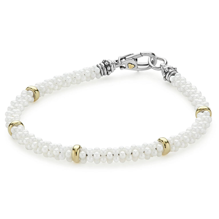 White Caviar Five Gold Station Ceramic Bracelet features twisted white caviar beads with 18K gold accents and a silver-tone clasp, showcasing LAGOS' elegance and quality.