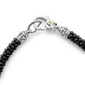 Close-up of Black Caviar Black Five Silver Station Ceramic Bracelets clasp, featuring shiny black beads, silver spacer rings, and a polished silver lobster-claw clasp with a gold-tone emblem.