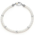 A white ceramic Caviar bracelet accented by five sterling silver stations.
