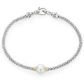 A cultured freshwater pearl station with Caviar beading in 18K gold and sterling silver form this versatile bracelet.