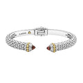 Caviar beading and highly polished sterling silver stations comprise this innovative cuff bracelet detailing garnet gemstone end caps.