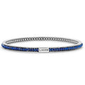 Lapis gemstones set with smoothly polished sterling silver forms this round bangle detailing the LAGOS logo.