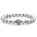 A highly polished sterling silver bracelet with a Caviar beaded accent.