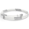 Ten sterling silver stations highlighted by white ceramic Caviar beading finished with fluted sterling silver endcaps form this coil bracelet.