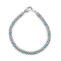 Eight smooth stations of blue ceramic accent sterling silver Caviar beading to form this versatile bracelet.