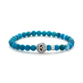 Blue apatite gemstone beaded bracelet with a sterling silver Caviar skull.