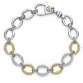 Three pavé diamond links, 18k gold and sterling silver create this classic link bracelet. LAGOS diamonds are the highest quality natural stones.