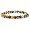 A tiger eye gemstone bracelet with five sterling silver Caviar beaded stations.