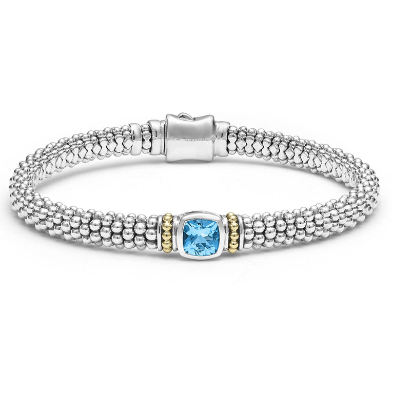 A swiss blue topaz gemstone and sterling silver Caviar beading with 18K gold detailing forms this bracelet.