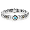 A swiss blue topaz gemstone and sterling silver Caviar beading with 18K gold detailing forms this bracelet.