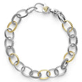 A two tone, sterling silver and 18k gold, link bracelet with alternating Caviar beading and smooth links.