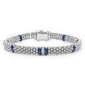 A single diamond station set in sterling silver surrounded by ultramarine ceramic and Caviar beading. LAGOS diamonds are the highest quality natural stones.