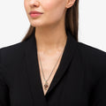 Rare Wonders Orange Sapphire and Diamond Seahorse Pendant Necklace in sterling silver and 18K gold, featuring orange sapphires and diamonds, elegantly draped over a black blazer.