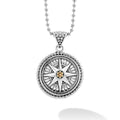 A signature LAGOS compass. Sterling silver and 18K gold with fluting and Caviar beading forms this compass pendant.