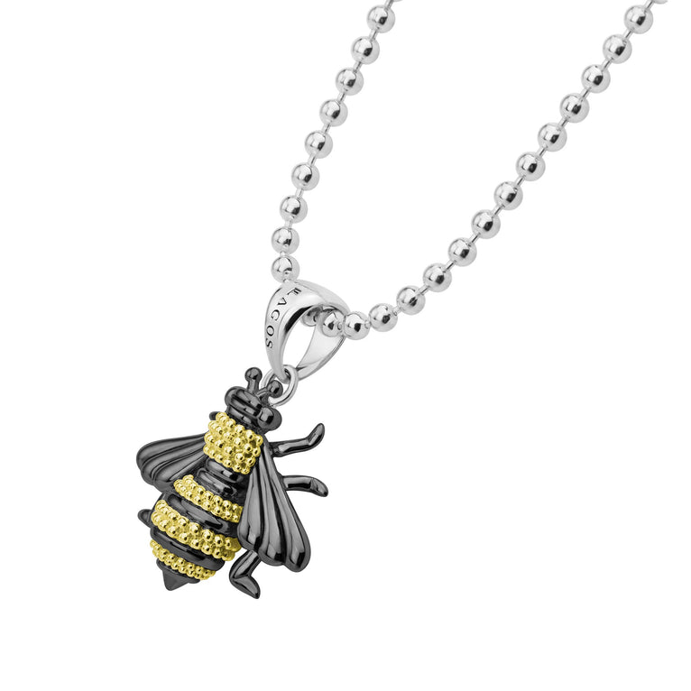 Rare Wonders Large Honeybee Necklace featuring a silver ball chain with a black-enamel bee pendant, adorned with 18K gold Caviar beading.