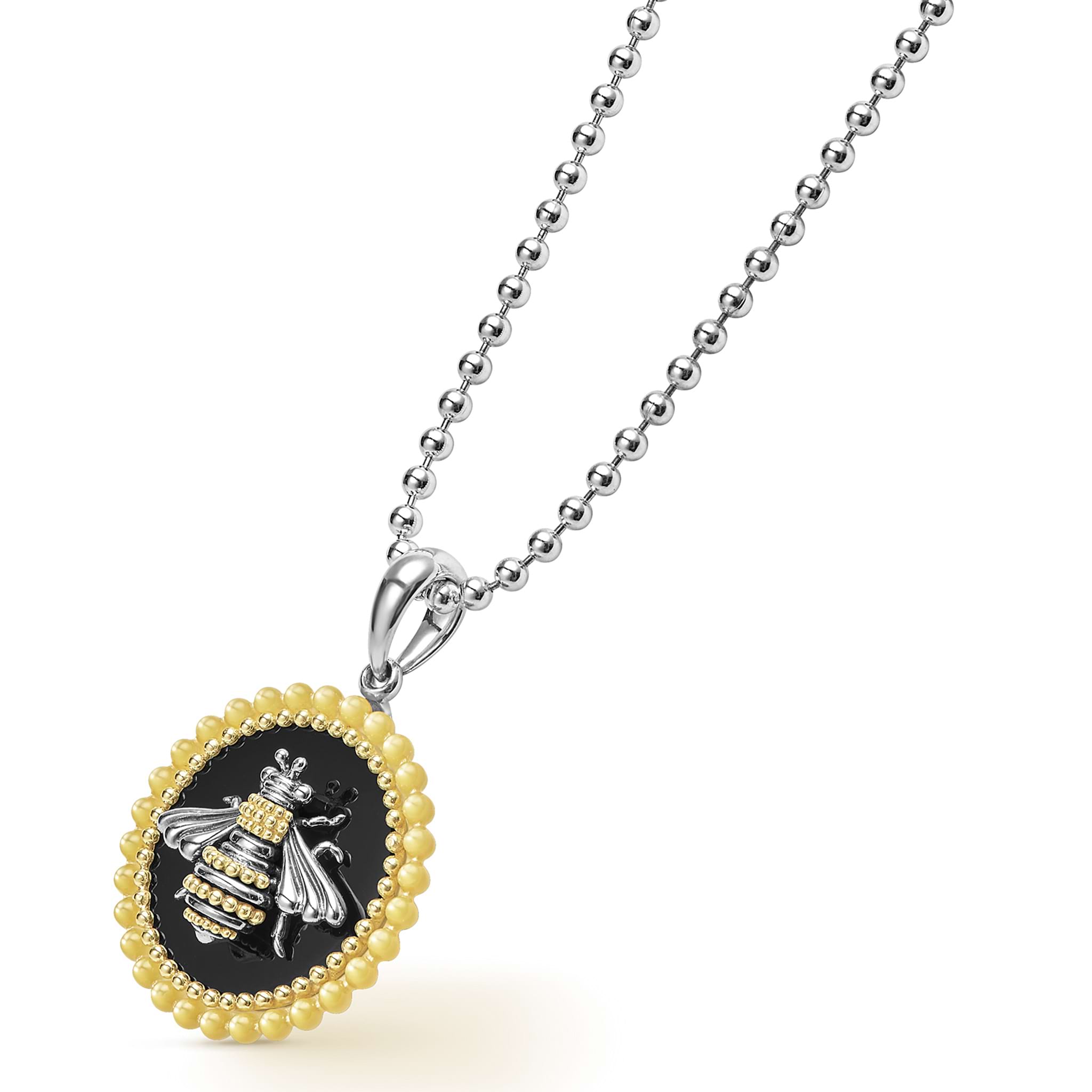 Close-up of the yellow mother-of-pearl honeybee on black onyx in the Rare Wonders Circle Pendant Necklace, showcasing intricate 18K gold Caviar beading