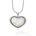 A white mother of pearl gemstone pendant framed by sterling silver Caviar beading in the shape of a heart finished on a ball chain necklace.