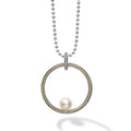 One cultured freshwater pearl sits in a large circle pendant detailed with Caviar beading in 18K gold and sterling silver. Finished on a 34 inch versatile ball chain necklace.